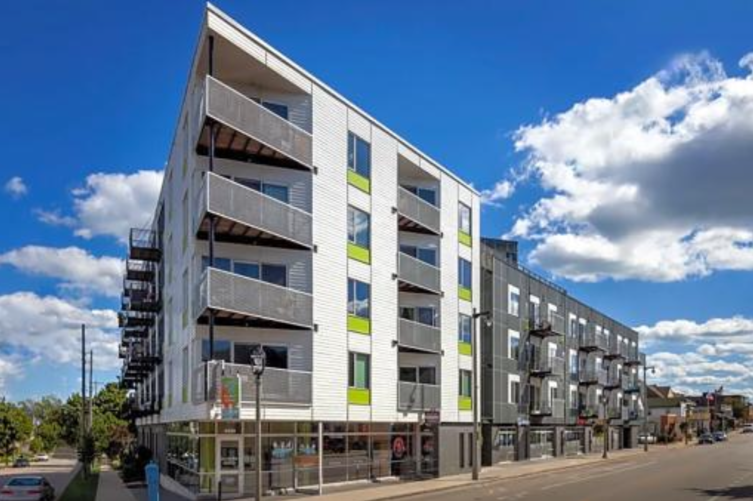 Green-accented midrise apartment building in Bay View